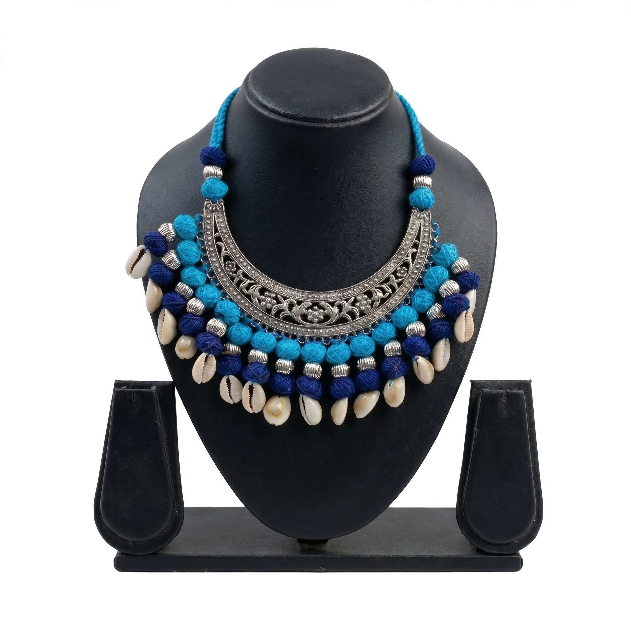 Bohemian blue thread and oxidized silver choker necklace with white cowrie shells on a black display stand.