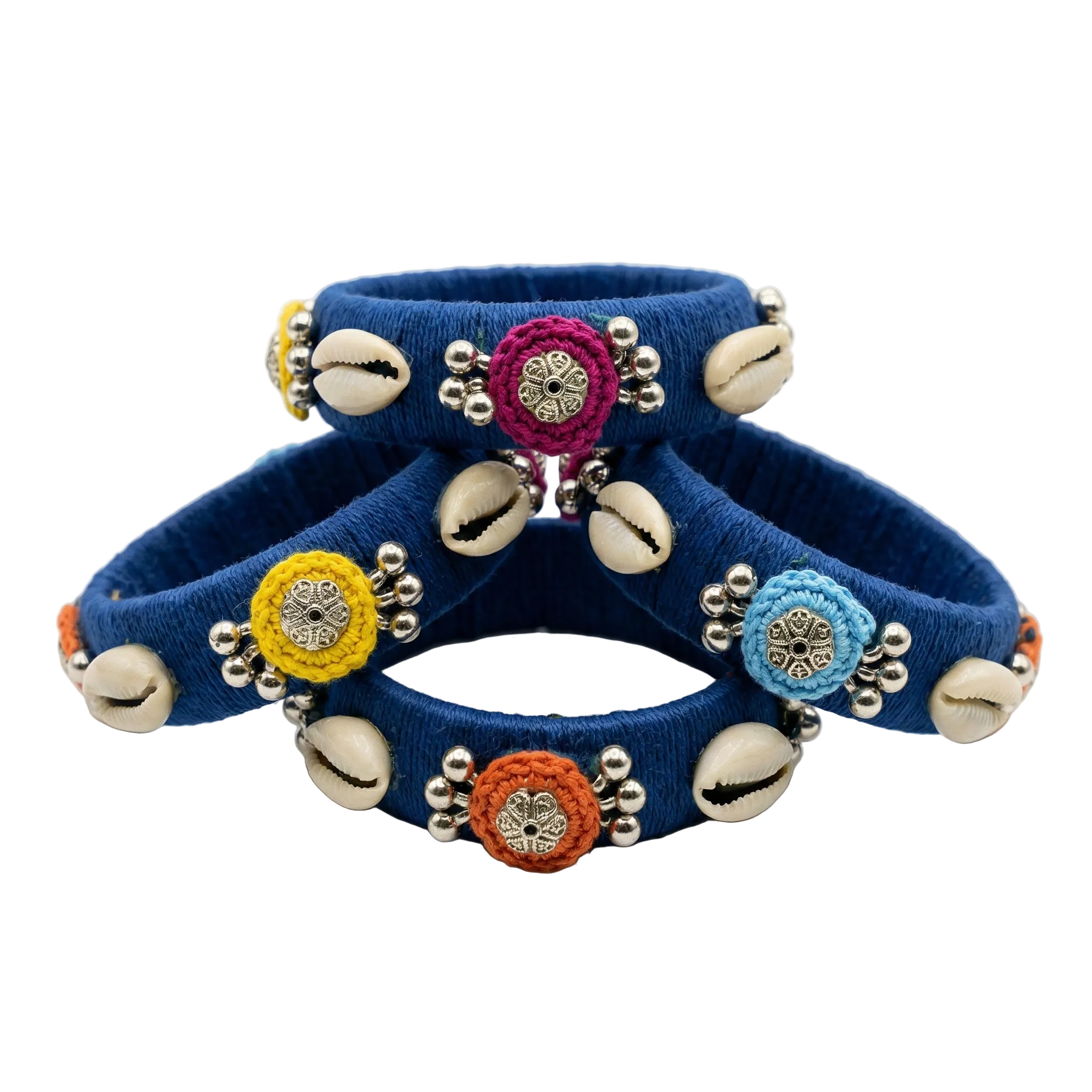Set of four deep blue silk thread wrapped bangles featuring white cowrie shells, colorful embroidered floral accents, and silver bead detailing on a white background.