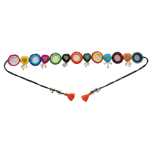 Traditional handcrafted belt featuring colorful embroidered fabric circles, round mirrors, silver beads, and hanging cowrie shells on a white background.