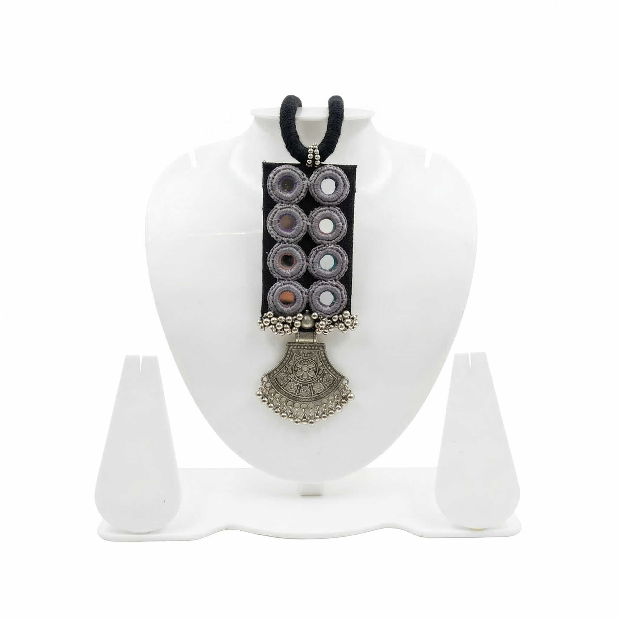 Handmade black fabric choker necklace featuring traditional mirror work embroidery and a vintage-style oxidized silver pendant on a white jewelry display stand.