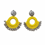 Pair of bright yellow silk thread crochet hoop earrings featuring silver oxidized floral studs and hanging metal ghungroo beads on a white background.