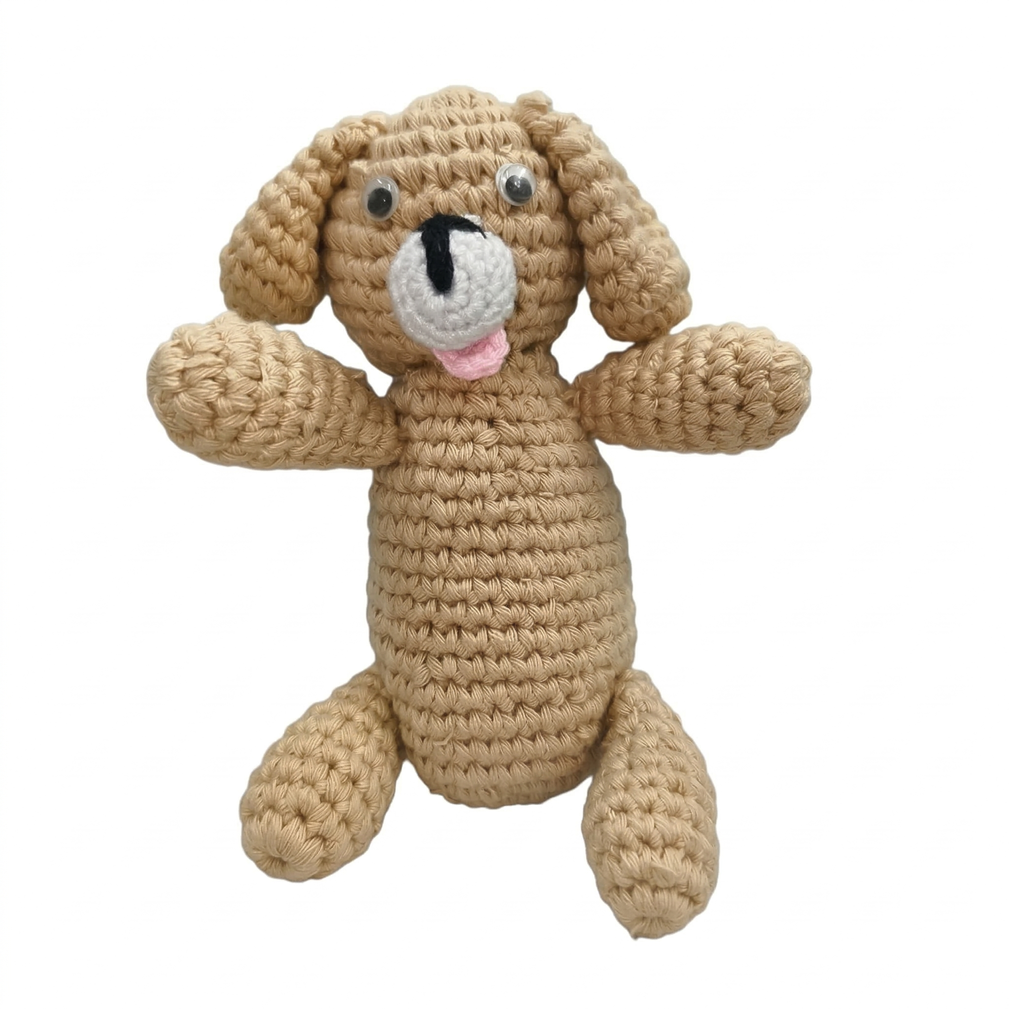 Close-up of a handmade beige crochet puppy dog with floppy ears, a white muzzle, and a pink tongue, isolated on a pure white background.