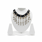 Black braided thread choker necklace featuring dangling oxidized silver coins and ghungroo bell charms on a white display stand.