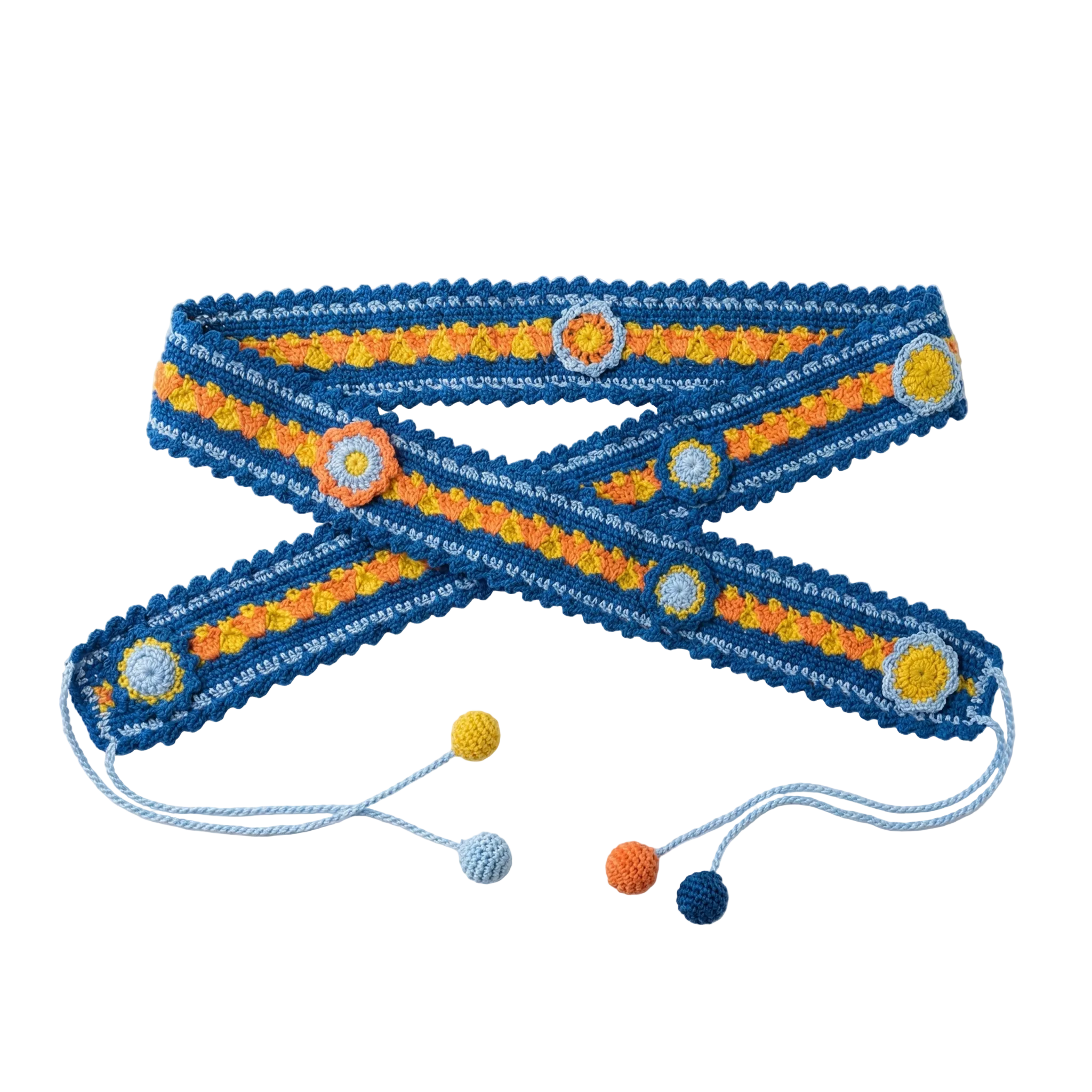 A flat lay photograph of a handmade blue crochet belt featuring orange and yellow floral motifs and light blue string ties with colorful pompoms on a white background.