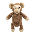 shot of a brown and cream handmade crochet monkey plush toy standing against a solid white background.