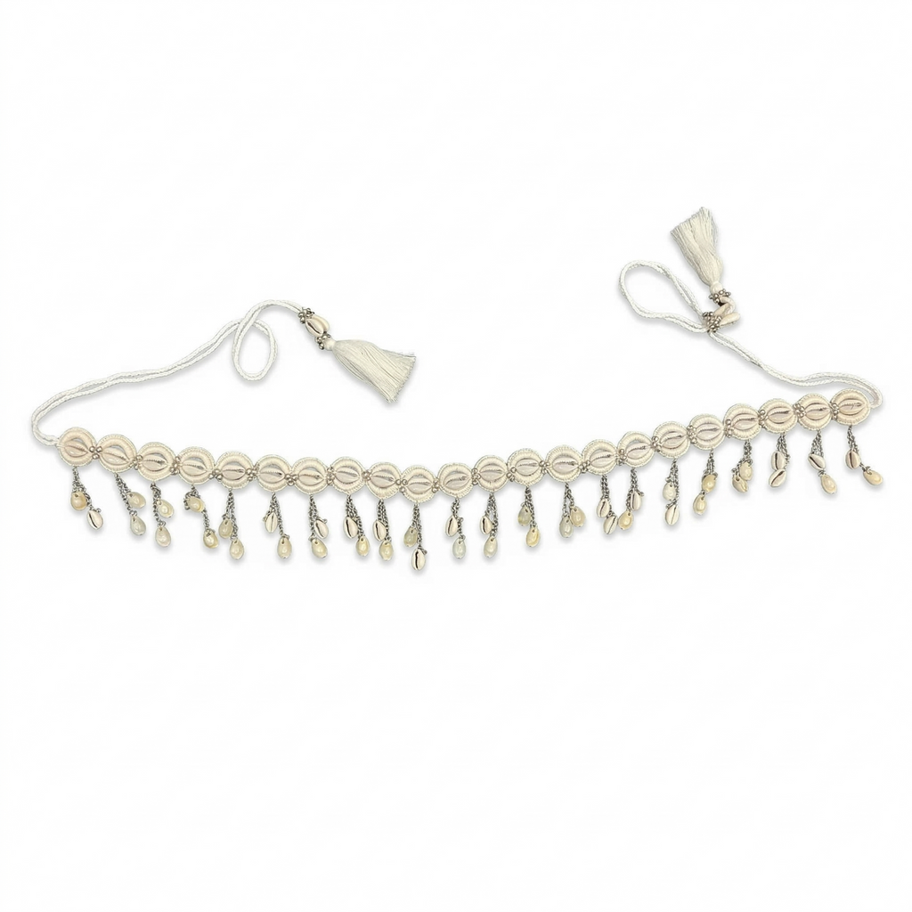 Handcrafted white cowrie shell choker necklace with hanging shell charms and adjustable tassel cord on a white background.