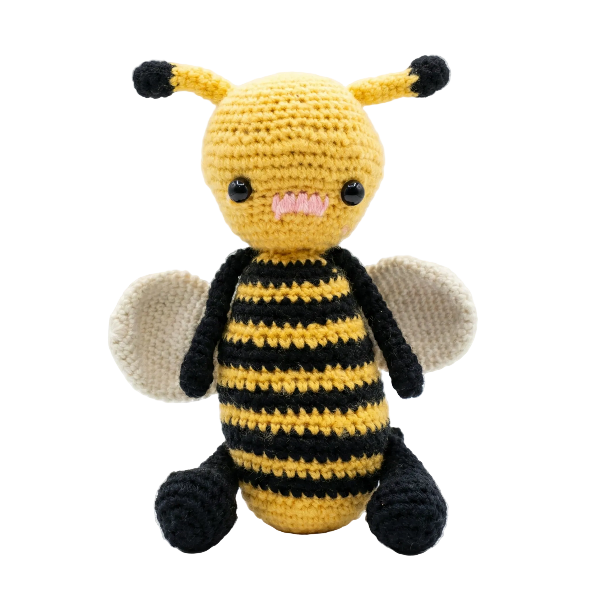 Handmade yellow and black crochet bumblebee plushie with white wings and pink mouth on a white background.