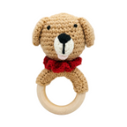 Handmade tan crochet dog rattle with red ruffled collar on a natural wood teething ring, isolated on a white background.