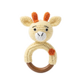 Yellow and orange crochet giraffe baby rattle toy on a natural wooden ring, isolated on a white background.