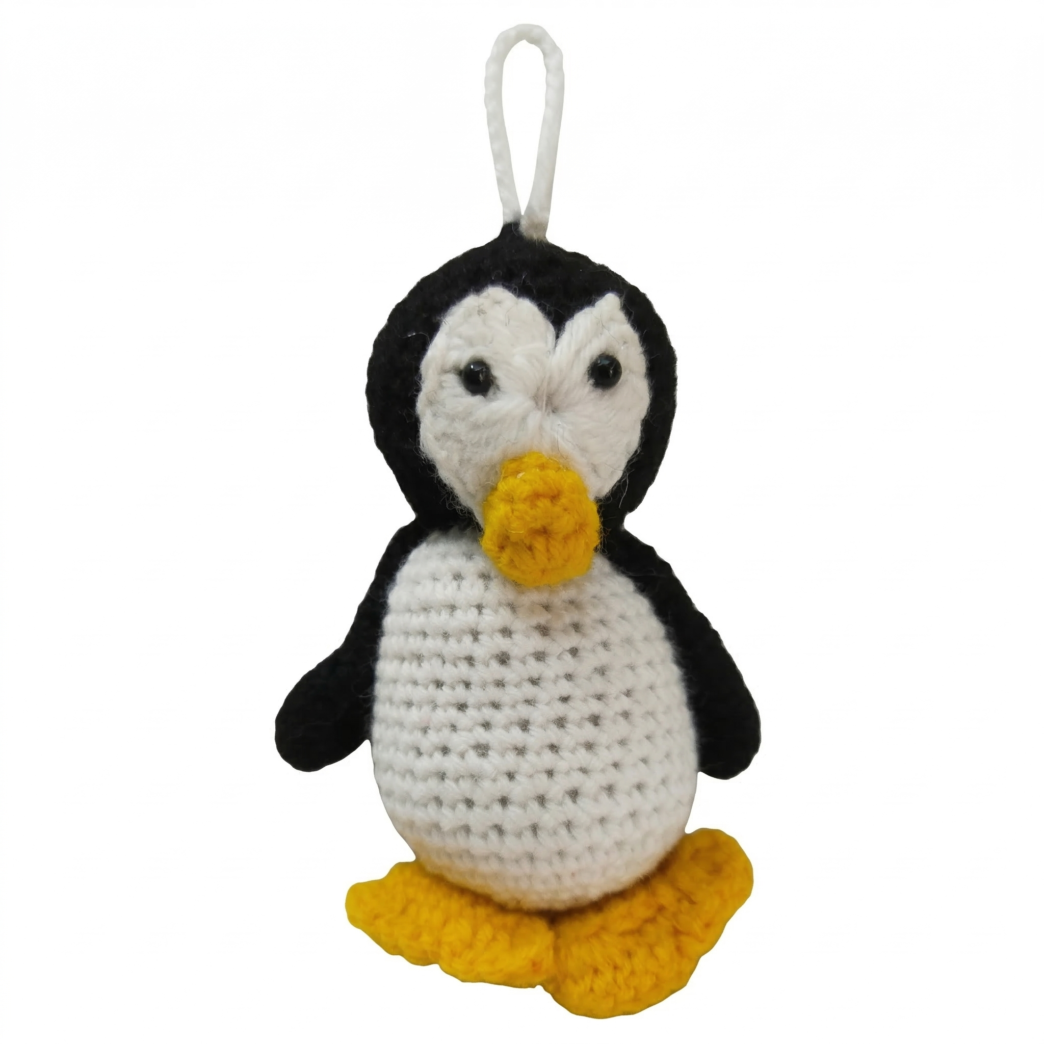 Handmade crochet penguin plushie with black and white yarn body, yellow beak, and hanging loop on a white background.