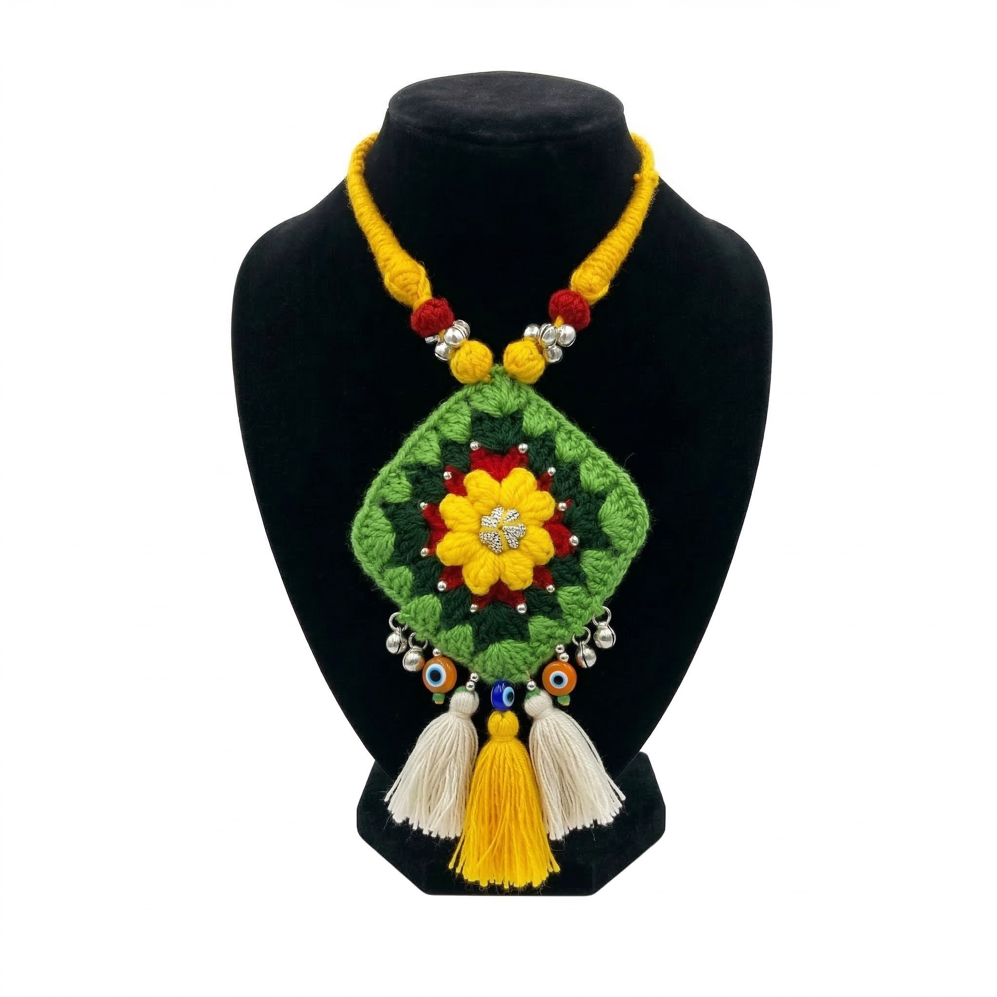 Bohemian green crochet diamond pendant necklace with yellow flower center, evil eye beads, and hanging tassels on a black display stand.