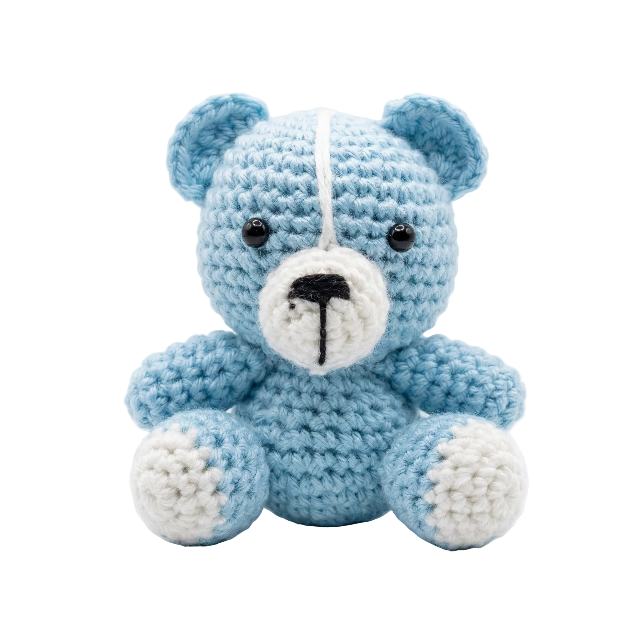 Small handmade light blue and white crochet teddy bear sitting against a plain white background, featuring black safety eyes and a stitched nose.