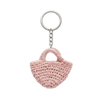 A light pink miniature crocheted tote bag attached to a silver metal keychain ring against a plain white background.