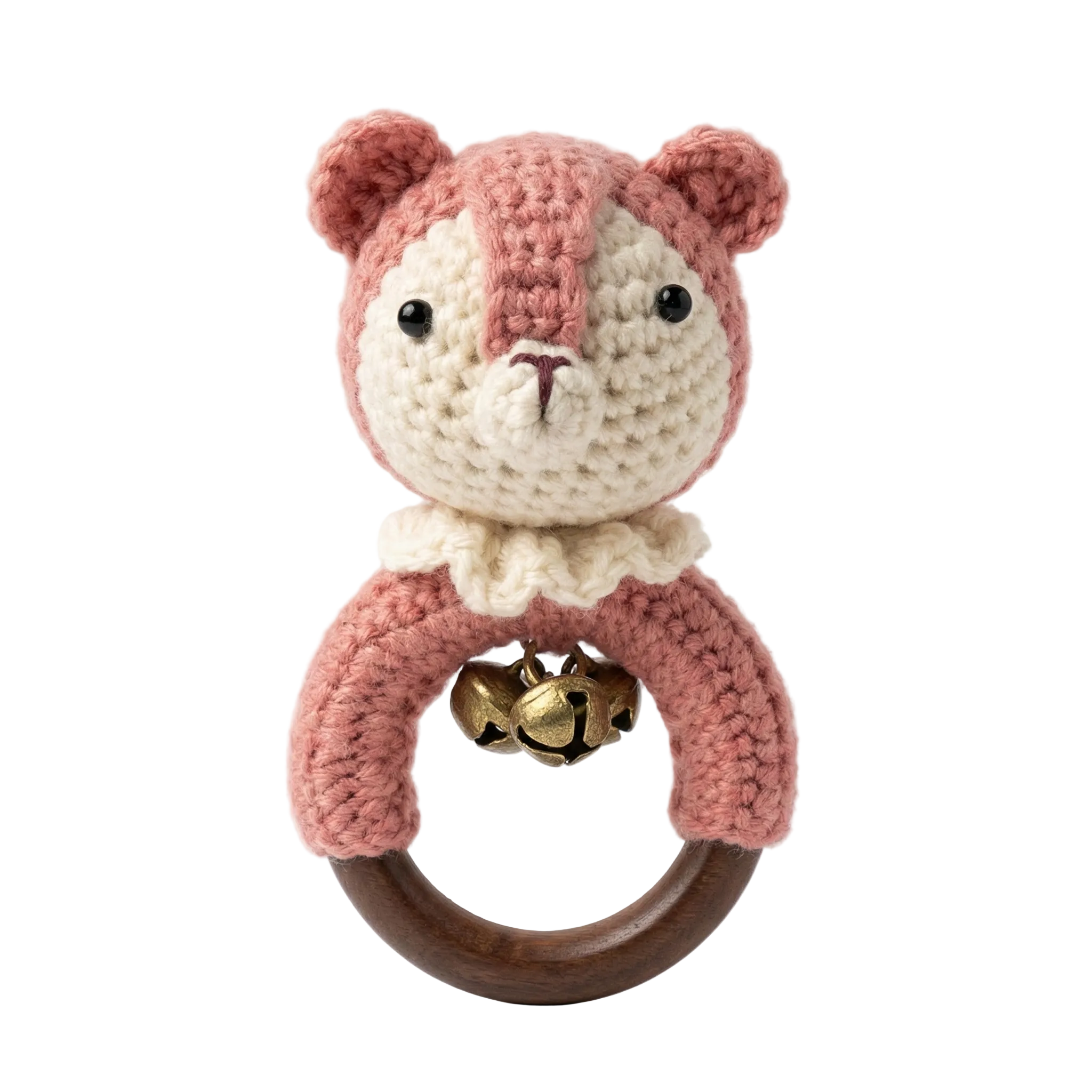 A pink and cream amigurumi fox baby rattle with a dark wooden ring, white crochet collar, and gold bells.