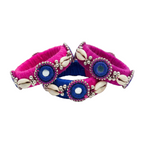 Handmade Pink and Blue Silk Thread Bangles with Cowrie Shells

Alt Text: A set of three vibrant pink and blue silk thread bangles decorated with white cowrie shells, silver beads, and embroidered mirror work on a white background.