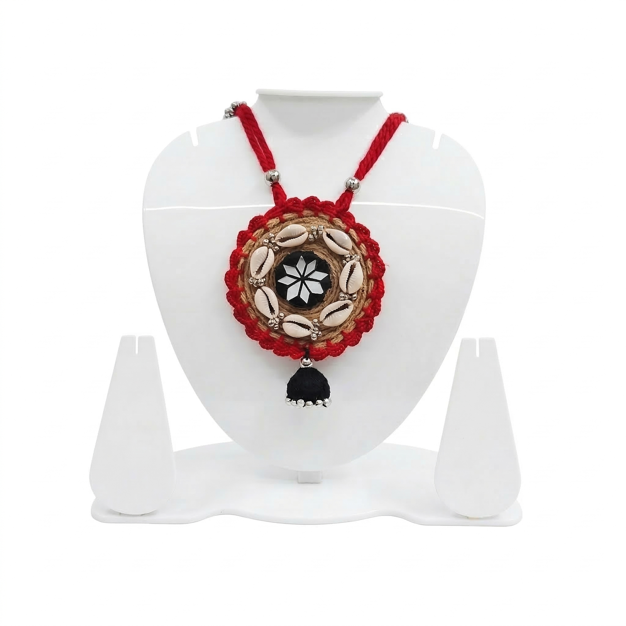 Traditional red handmade necklace on a white display stand featuring jute embroidery, cowrie shells, and a central mirror star design.