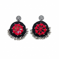 Pair of handcrafted black and red thread work earrings featuring center mirror inlay and oxidized silver bead droplets on a white background.
