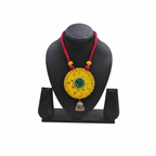 Handcrafted yellow fabric pendant necklace featuring green mirror work, pink thread cord, and a silver oxidised jhumka hanging.