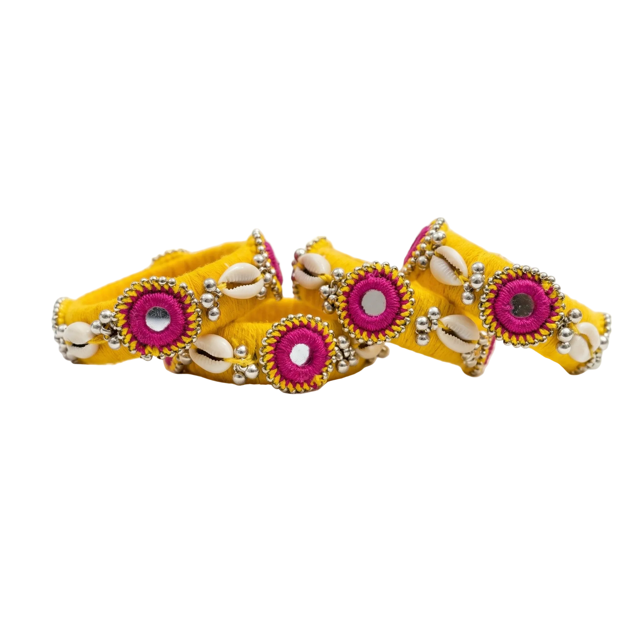 Set of four yellow silk thread wrapped bangles featuring traditional mirror work, white cowrie shells, and silver bead accents on a white background.