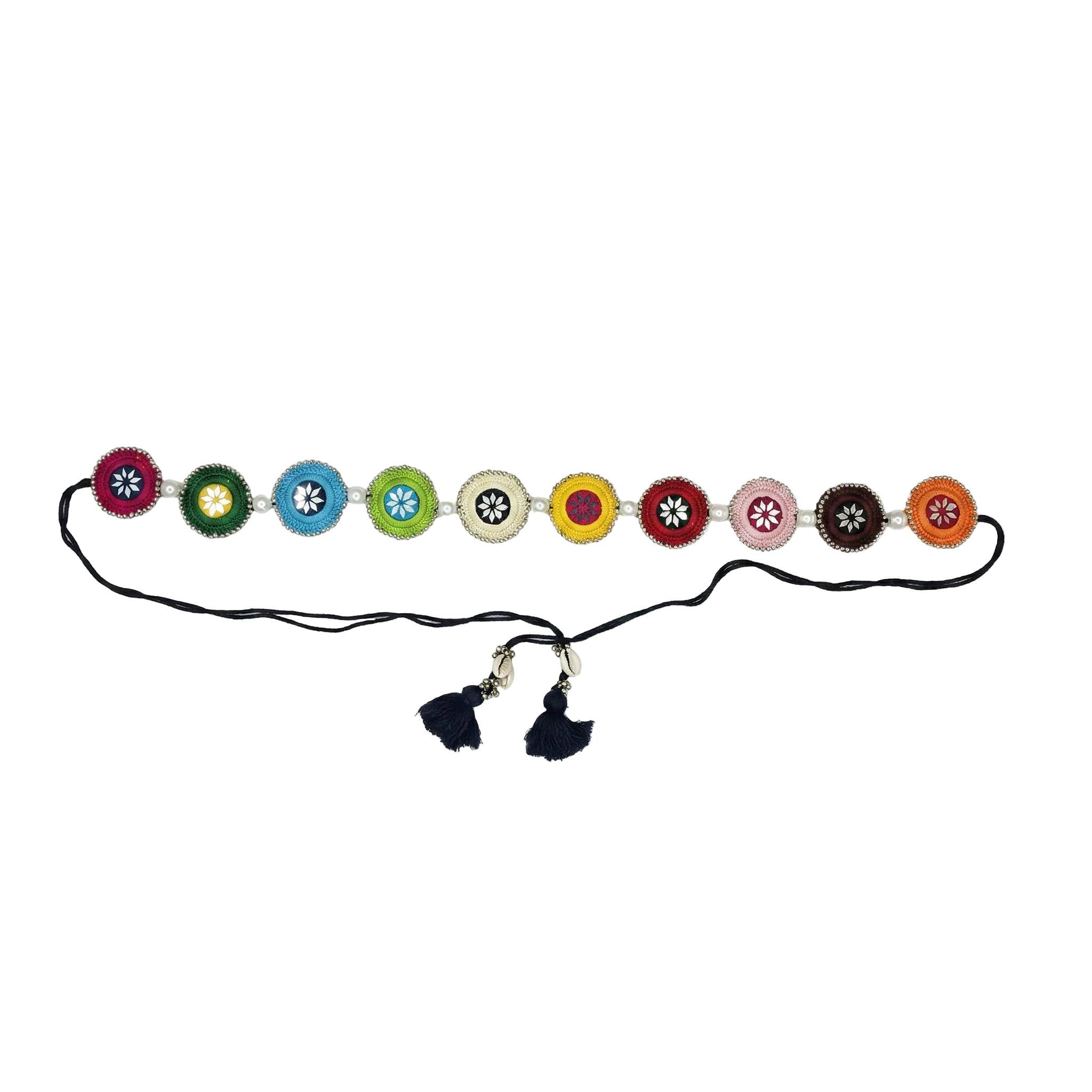Vertical view of a black fabric belt featuring ten colorful circular patches with white floral embroidery and mirror work accents, finished with black tassels and cowrie shells.