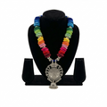 Vibrant rainbow thread-wrapped bead necklace with a large intricate oxidized silver floral pendant and hanging jhumka bead.