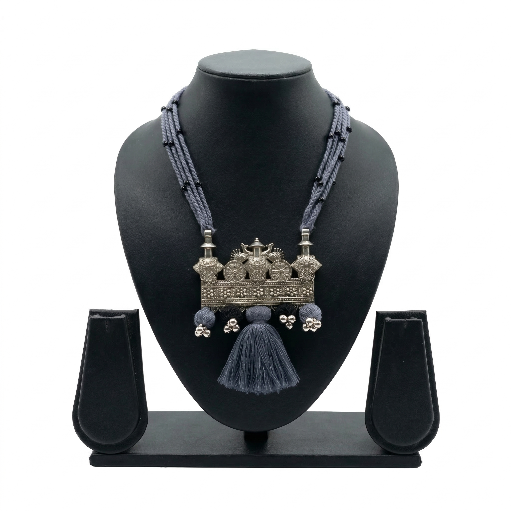 Handcrafted oxidized silver tribal pendant on multi-strand grey thread necklace with tassels.