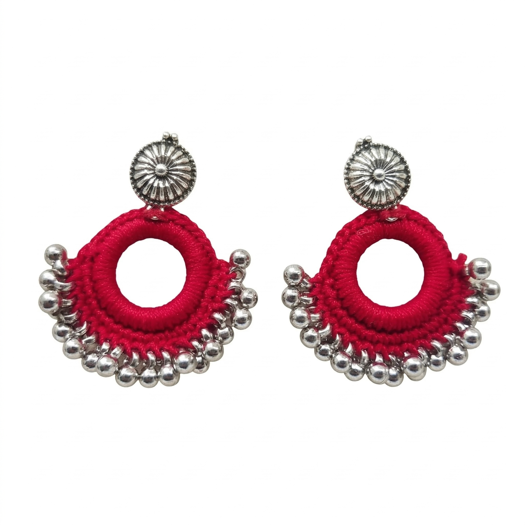 Pair of red thread-wrapped crochet hoop earrings featuring oxidized silver sun-studs and metallic bead fringe on a white background.