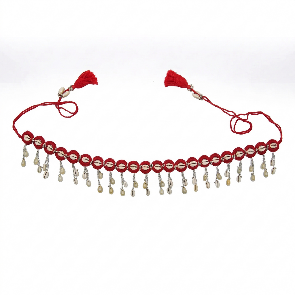 Traditional red thread waist belt featuring hanging cowrie shells and silver chains with red tassels on a white background.