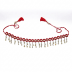 Traditional red thread waist belt featuring hanging cowrie shells and silver chains with red tassels on a white background.